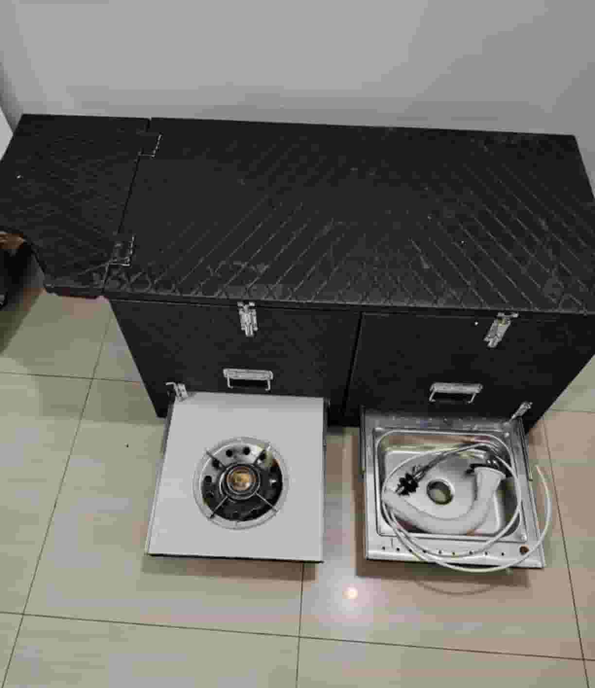 For sale a box equipped for trips with a gas tank and a laundry