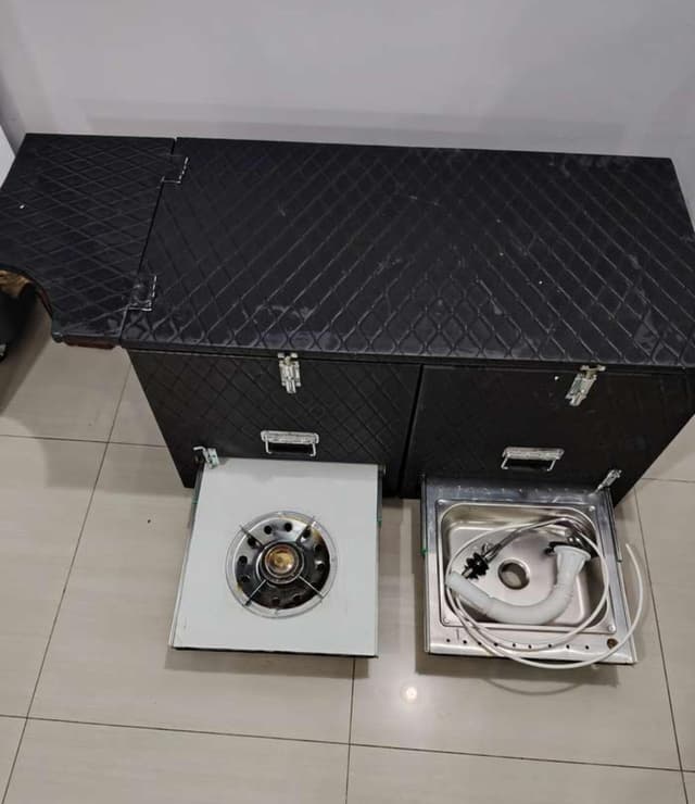 For sale a box equipped for trips with a gas tank and a laundry