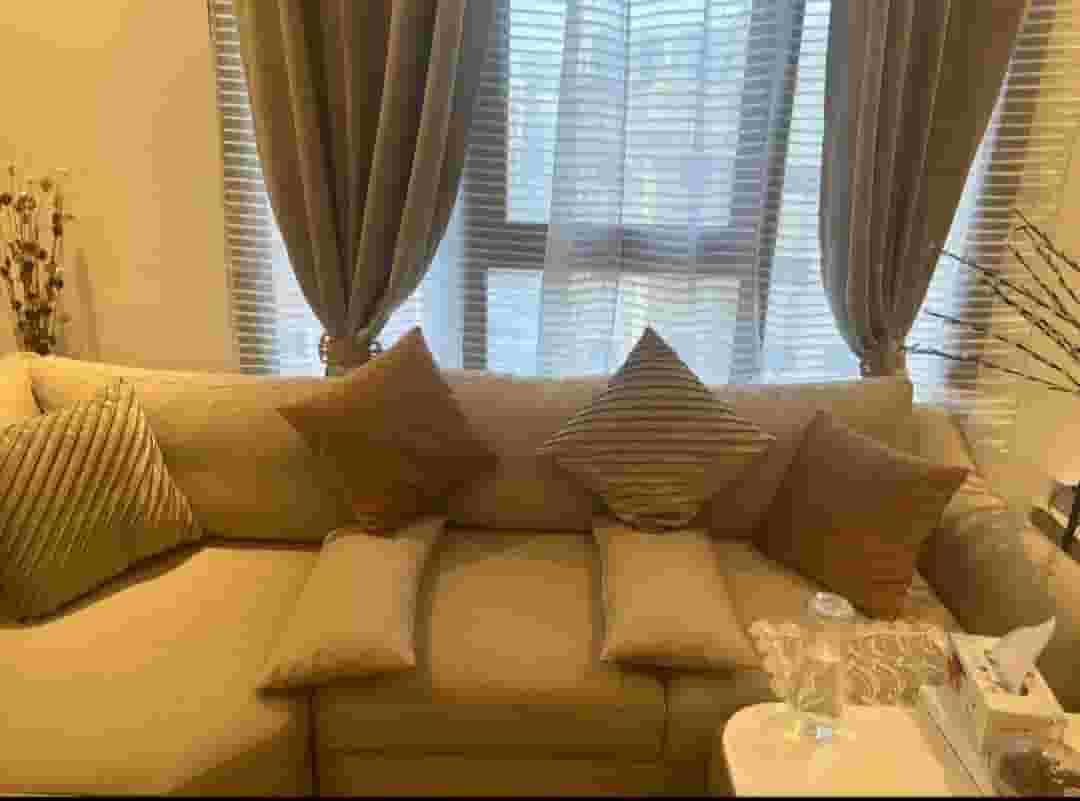 A sofa with the letter L with a table with 4 pouf A sofa with the letter L with a table with 4 pouf